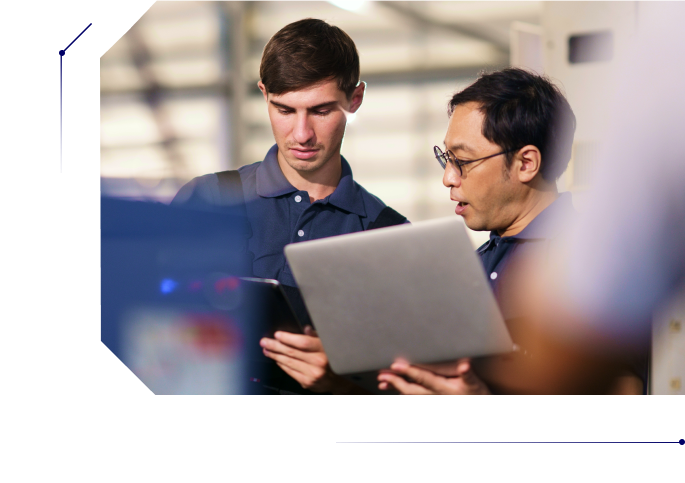 Two men discussing work while using their laptops