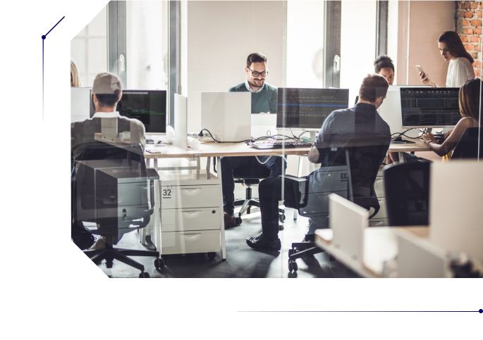 A group of people in one room writing code in their computers
