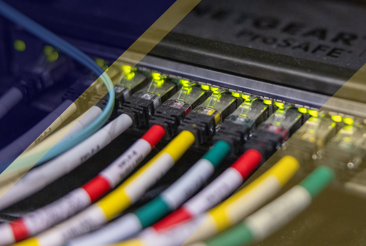 Close-up of a network switch with multiple Ethernet cables plugged in, green status lights glowing along the ports in a server rack environment.
