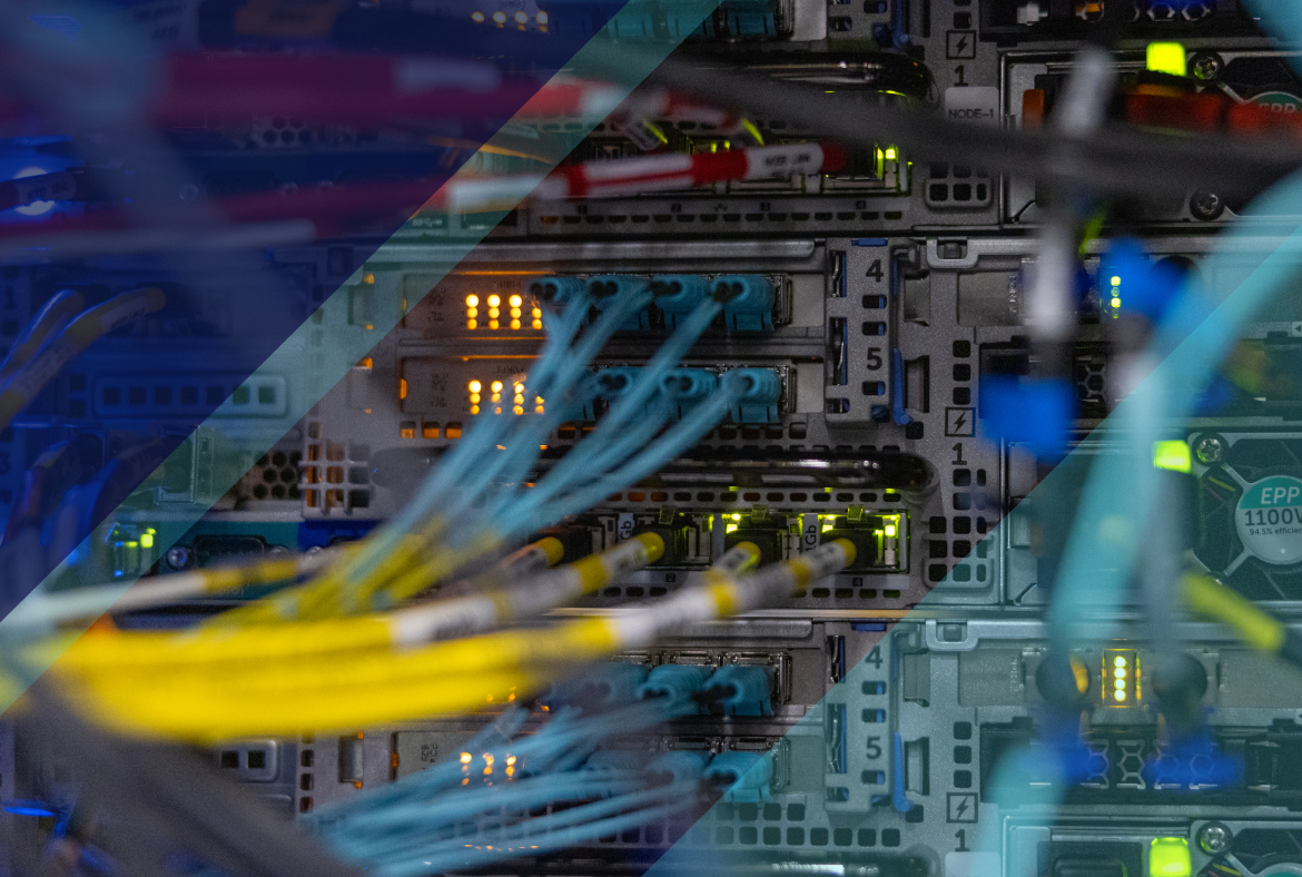 Close-up of data center networking hardware with connected fiber optic cables and glowing status lights, showing active server infrastructure.
