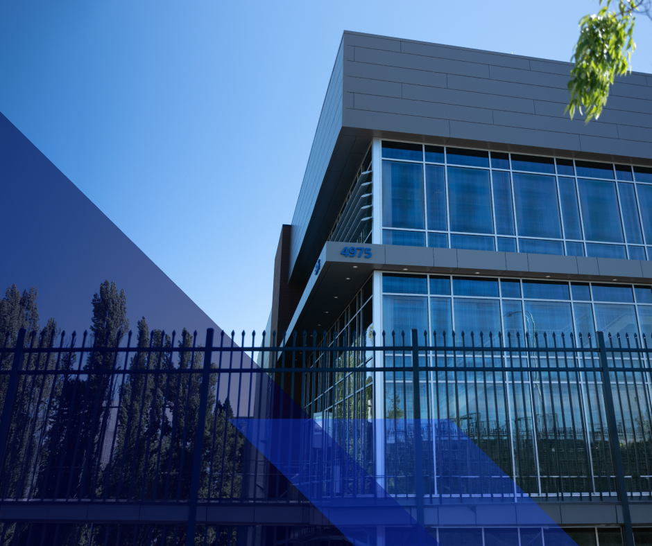 Modern glass-and-metal office or data center building with blue windows