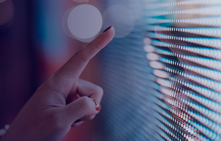 a woman's finger pointing to a digital screen
