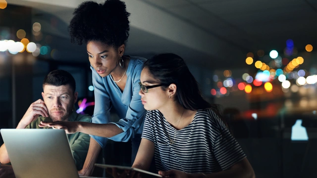 Two individuals looking at a computer screen