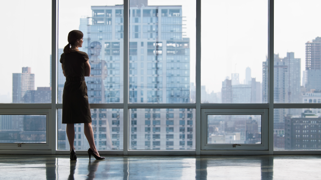 individual looking at the skyline out the window