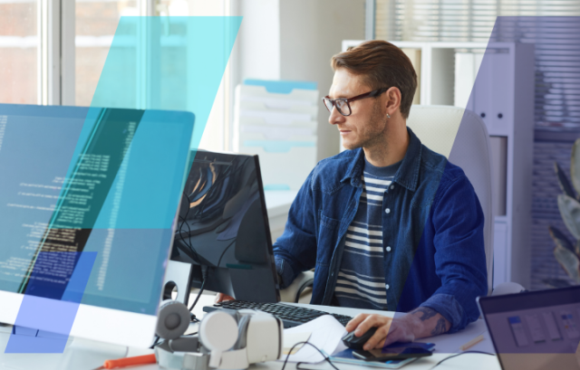 Person working at a desktop with code on screen in a modern office, wearing glasses, with tech gear and blue graphic overlays in foreground