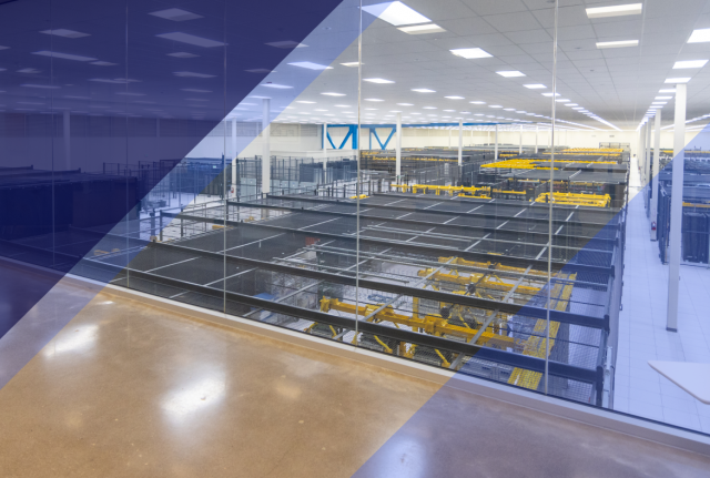 Interior of a large data center with rows of server racks, yellow cable trays, seen through a glass wall with a blue diagonal overlay