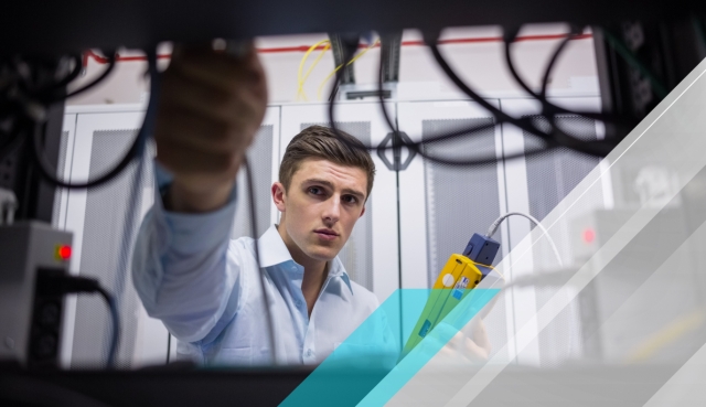 Technician inspecting network cabling in a server room while holding a testing device, with blue geometric overlays and data center equipment.