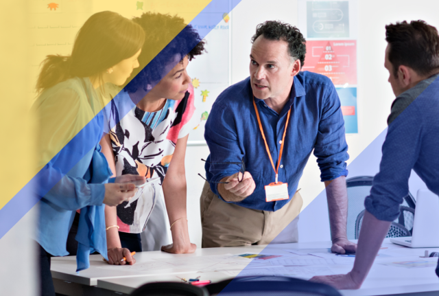 Team collaborating around a conference table during a planning meeting, with blue and gold geometric overlays across the image.